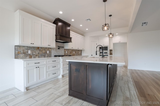 2044 E 129th Pl S, Jenks, OK 74037 - kitchen featuring a sink, tasteful backsplash, light countertops, white cabinetry, and recessed lighting
