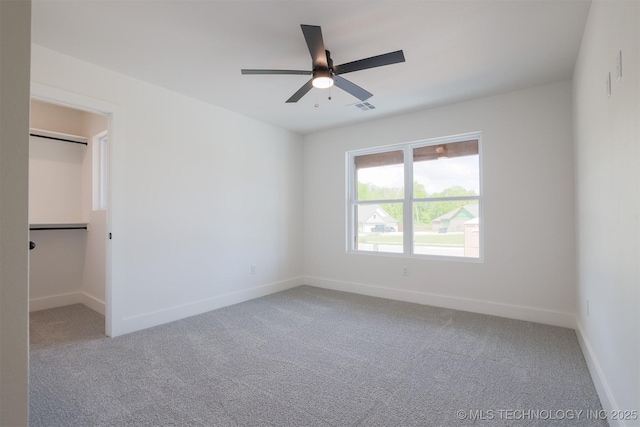 2044 E 129th Pl S, Jenks, OK 74037 - unfurnished bedroom featuring carpet flooring, baseboards, a walk in closet, and ceiling fan