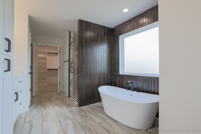 2044 E 129th Pl S, Jenks, OK 74037 - bathroom with marble look tile flooring, a freestanding bath, a shower stall, a spacious closet, and recessed lighting