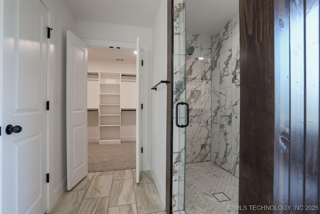 2044 E 129th Pl S, Jenks, OK 74037 - full bathroom featuring a marble finish shower, a spacious closet, and marble look tiles