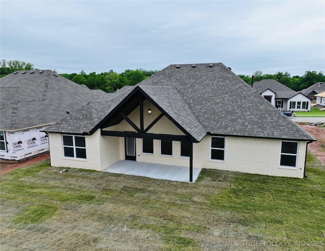 2044 E 129th Pl S, Jenks, OK 74037 - rear view of property featuring a shingled roof, a patio area, brick siding, and a yard