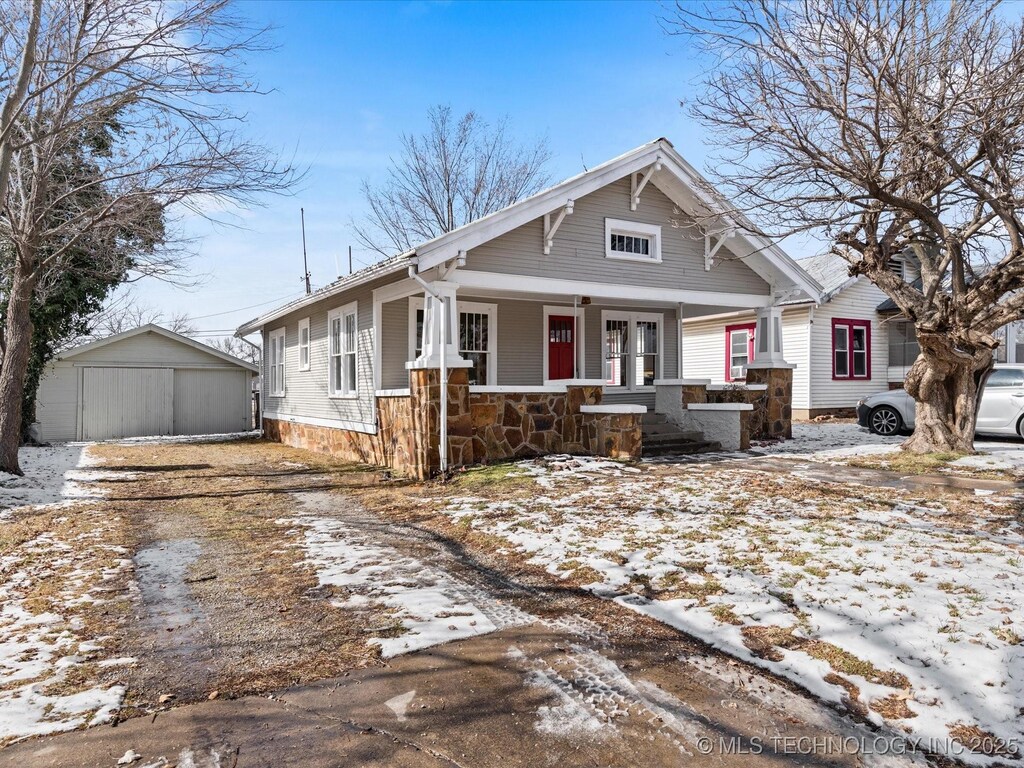 view of front facade with a shed and covered porch