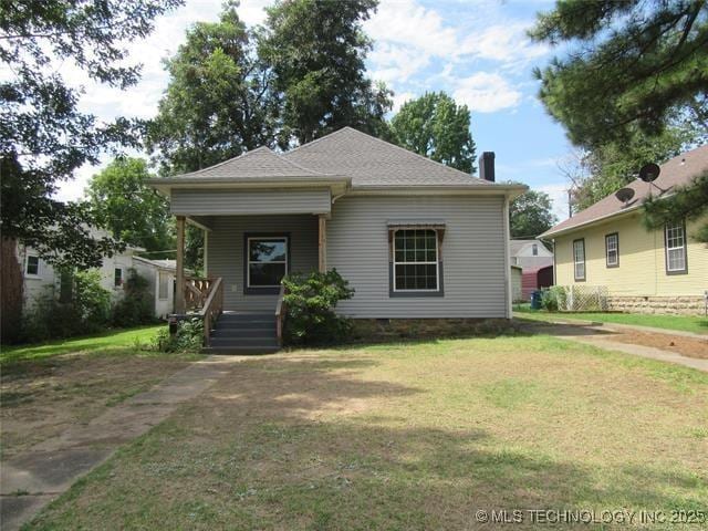 view of front of house featuring a front yard and covered porch