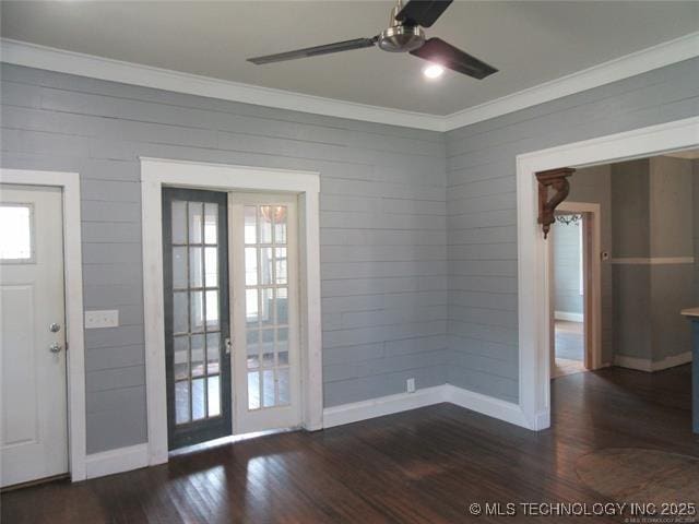 doorway to outside with dark wood-type flooring, ceiling fan, and crown molding