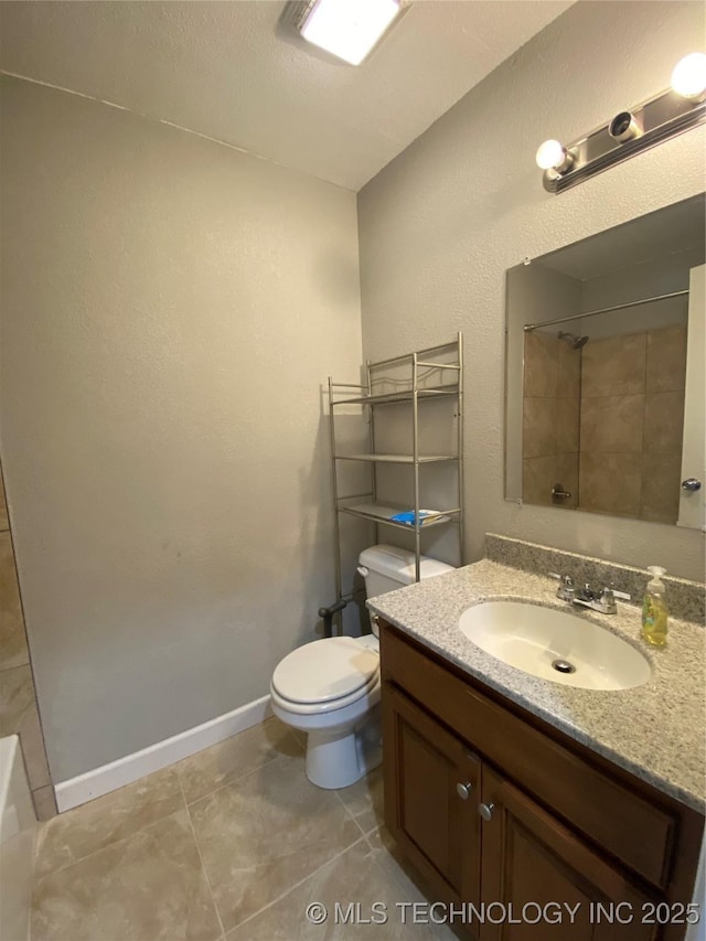 bathroom with vanity, tiled shower, tile patterned floors, and toilet