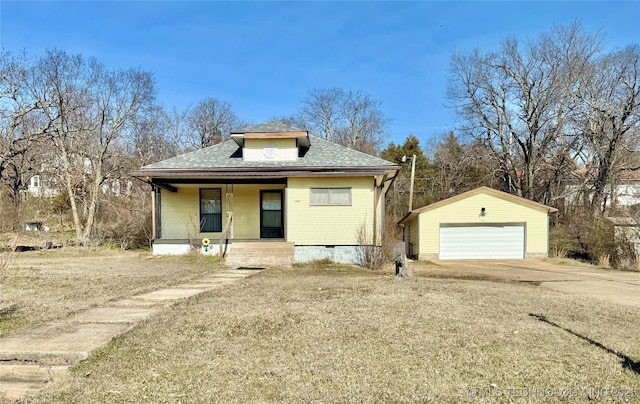 bungalow with a garage, a porch, and an outbuilding