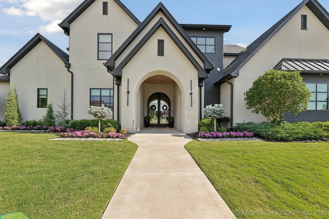 7300 E College St, Broken Arrow, OK 74014 - view of front facade with french doors, stucco siding, and a front lawn