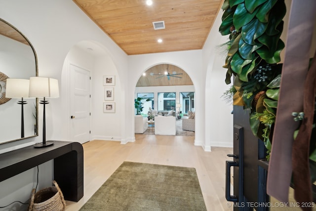 entryway featuring light wood-type flooring, vaulted ceiling, ceiling fan, and wooden ceiling