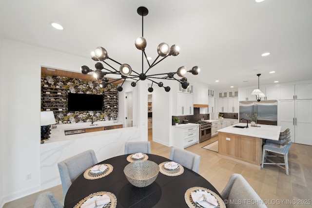 dining area featuring sink and light hardwood / wood-style flooring