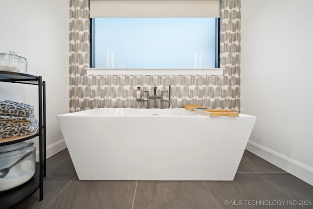 bathroom featuring a washtub and tile patterned flooring