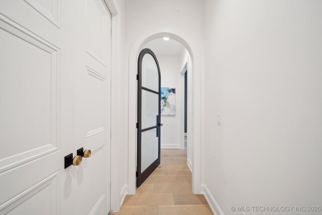 7300 E College St, Broken Arrow, OK 74014 - corridor featuring arched walkways, light wood-style flooring, and baseboards