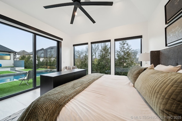 bedroom with multiple windows, access to exterior, and ceiling fan