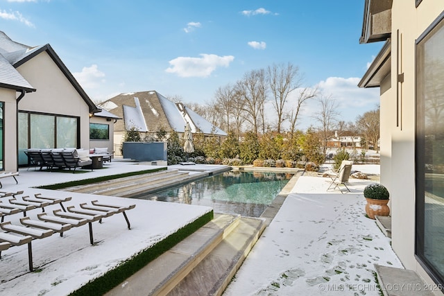 snow covered pool featuring a patio