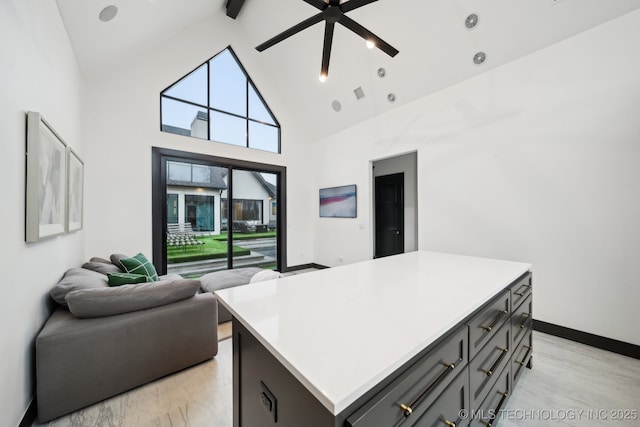 7300 E College St, Broken Arrow, OK 74014 - kitchen featuring a ceiling fan, a kitchen island, high vaulted ceiling, light countertops, and open floor plan