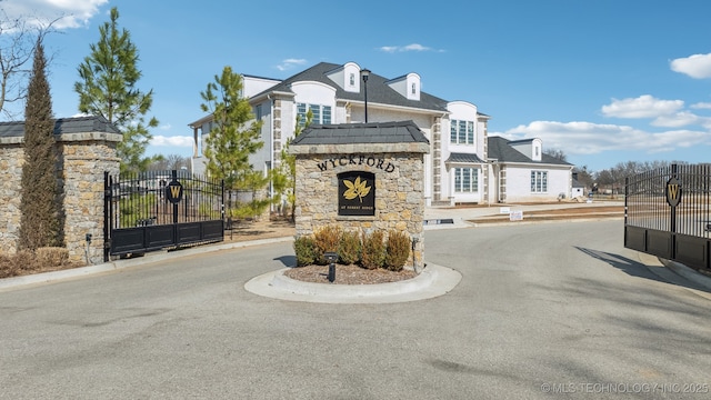 7300 E College St, Broken Arrow, OK 74014 - view of asphalt street featuring a gate, a gated entry, and curbs