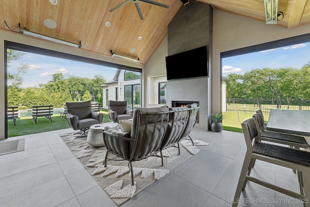 7300 E College St, Broken Arrow, OK 74014 - view of patio featuring an outdoor living space with a fireplace, ceiling fan, and view of wooded area