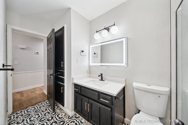 bathroom featuring hardwood / wood-style flooring, vanity, and toilet