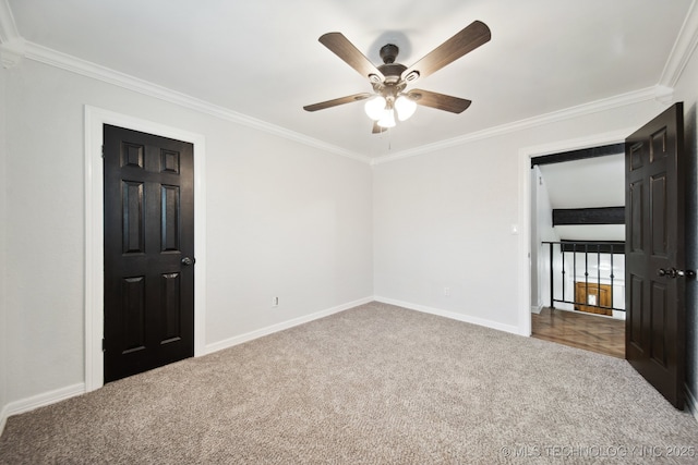 unfurnished bedroom with carpet, ornamental molding, and ceiling fan