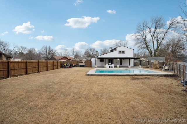 view of swimming pool with a patio, a lawn, and an outdoor structure