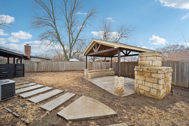 view of yard with a patio and central AC unit