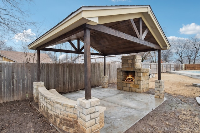 view of patio / terrace featuring an outdoor stone fireplace