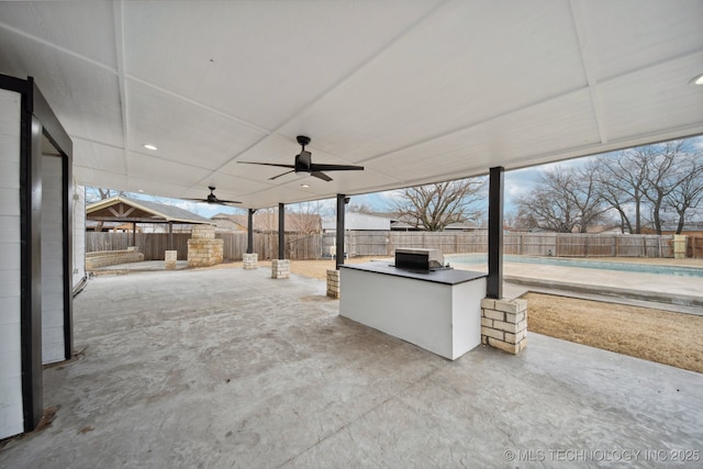 view of patio featuring ceiling fan and exterior kitchen