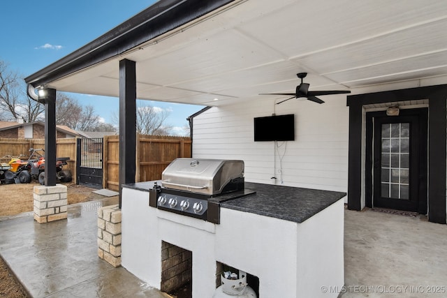 view of patio / terrace with an outdoor kitchen, ceiling fan, and a grill