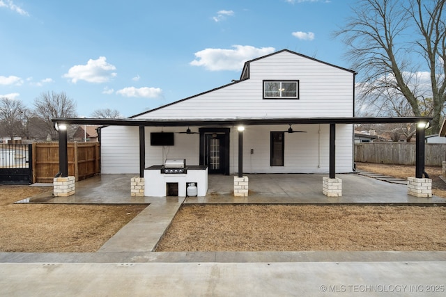 view of front facade with a patio, area for grilling, and ceiling fan