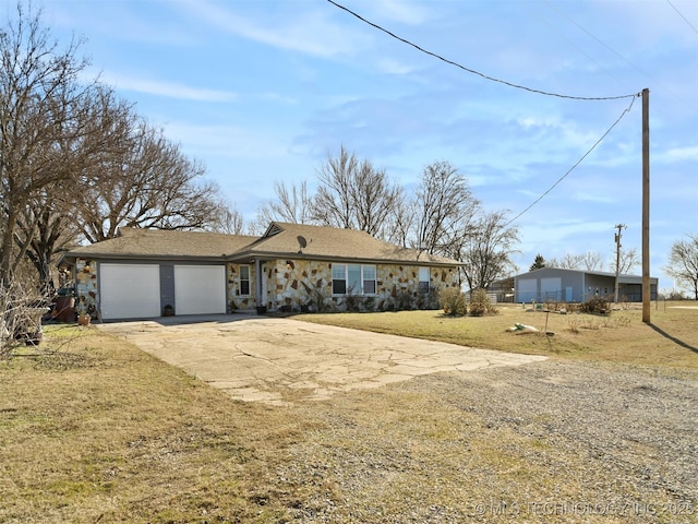 ranch-style home featuring a garage and a front lawn