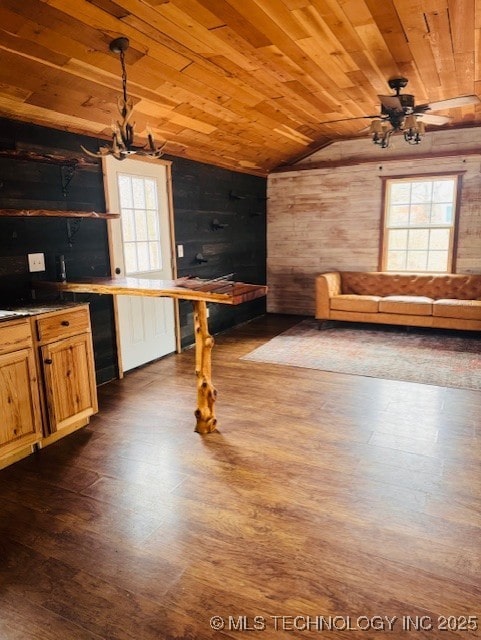 kitchen featuring dark wood-type flooring, lofted ceiling, wood ceiling, an inviting chandelier, and hanging light fixtures