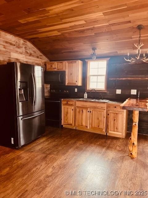 kitchen with a wealth of natural light, stainless steel fridge, dark hardwood / wood-style flooring, wood ceiling, and black / electric stove