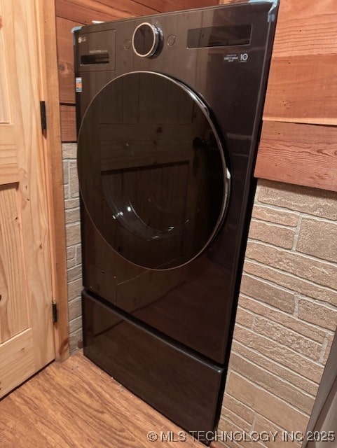 interior details featuring hardwood / wood-style floors and washer / dryer