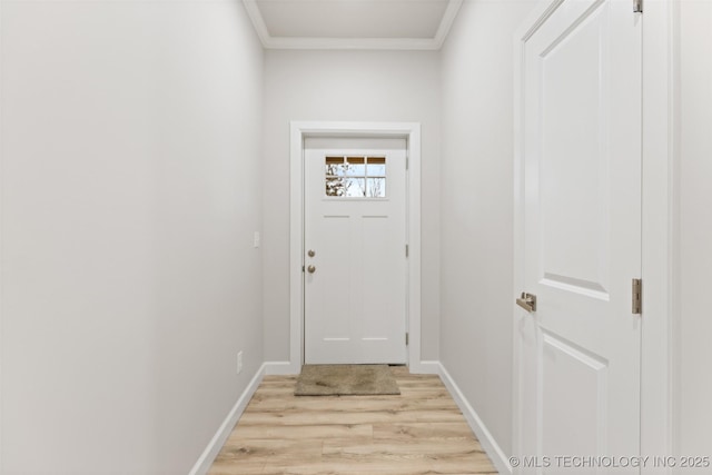 entryway featuring ornamental molding and light wood-type flooring