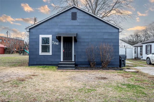 bungalow-style house featuring a yard