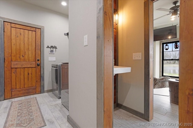 hall featuring light hardwood / wood-style floors and independent washer and dryer