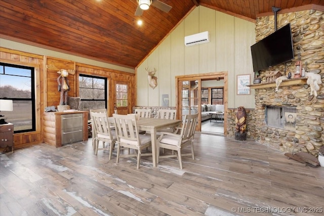 unfurnished dining area with a wall mounted air conditioner, wood ceiling, hardwood / wood-style floors, and high vaulted ceiling