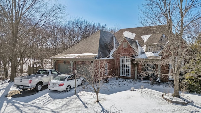 view of front of house with a garage and brick siding