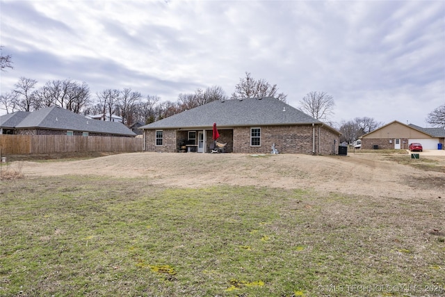 rear view of house featuring a yard