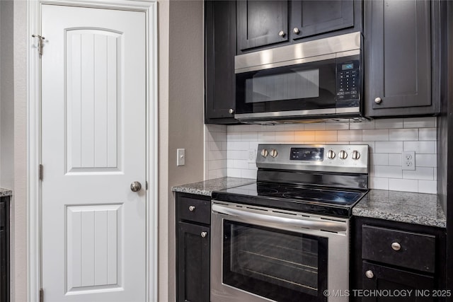 kitchen with appliances with stainless steel finishes, light stone countertops, and backsplash