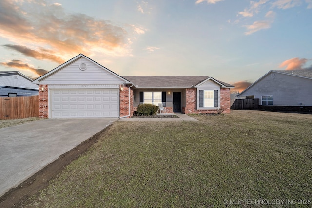 ranch-style home with a garage, driveway, brick siding, and a front yard