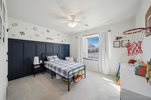 bedroom featuring a ceiling fan, visible vents, and light carpet