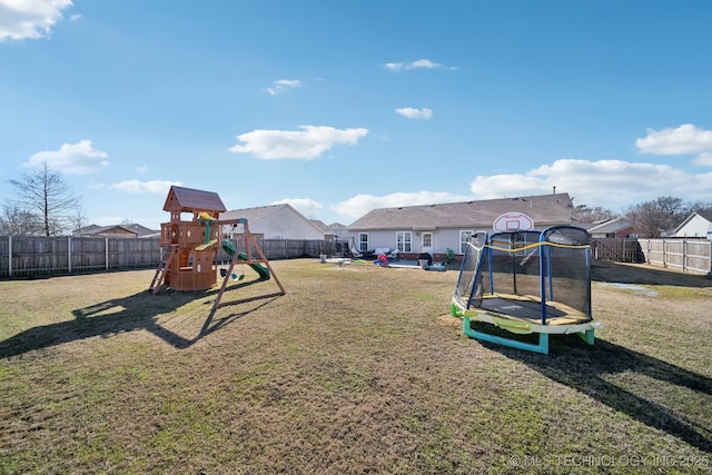 view of playground with a fenced backyard, a trampoline, and a yard