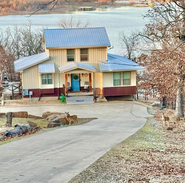 view of front of house with covered porch and a water view