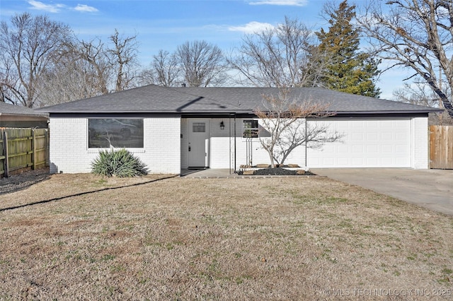 ranch-style home featuring a garage, brick siding, fence, driveway, and a front yard