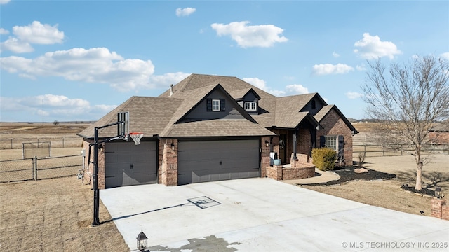 view of front facade featuring a garage, fence, concrete driveway, and brick siding