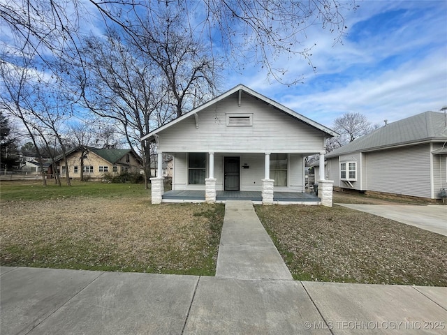 bungalow-style house featuring a porch and a front yard