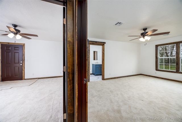 719 W Evergreen, Durant, OK 74701 - spare room featuring baseboards, visible vents, ceiling fan, and carpet