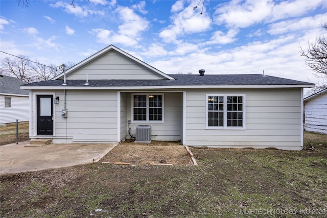 719 W Evergreen, Durant, OK 74701 - rear view of house featuring central AC unit, fence, a patio, and a shingled roof
