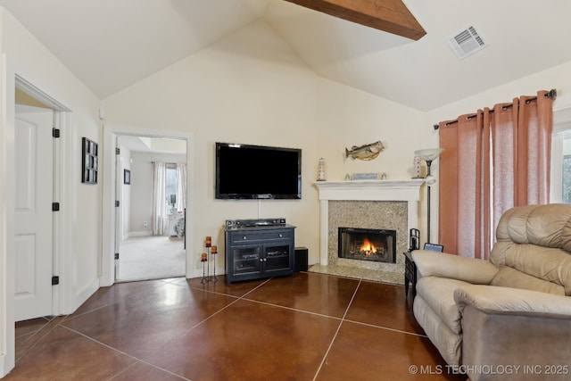 living room featuring visible vents, high vaulted ceiling, concrete floors, a lit fireplace, and baseboards
