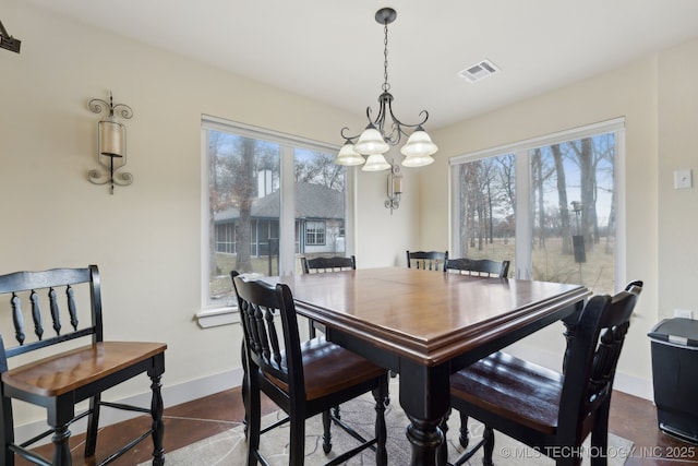 dining room featuring visible vents and baseboards
